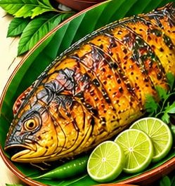 Whole spiced fish on a banana leaf with lime slices